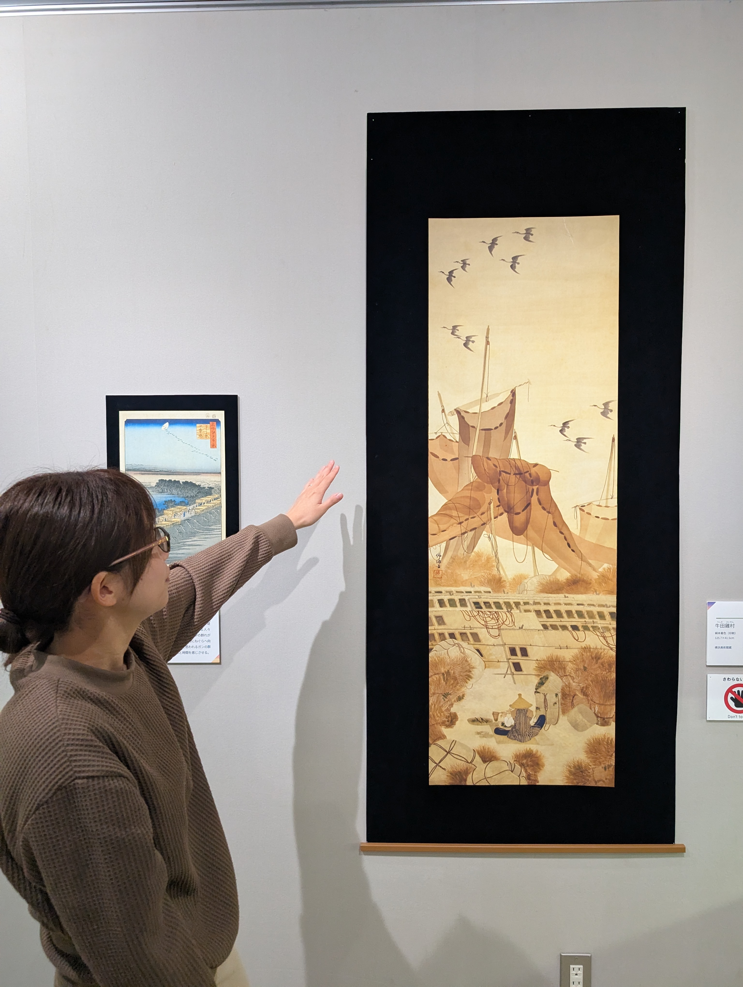 自然の博物館で作品を解説する学芸員